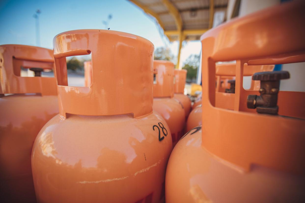 Group of orange LPG tanks, no people.