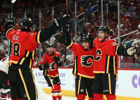 Nov 25, 2018; Glendale, AZ, USA; Calgary Flames defenseman Noah Hanifin (55) celebrates a goal with center Derek Ryan (10) and left wing James Neal (18) against the Arizona Coyotes in the second period at Gila River Arena. Mandatory Credit: Mark J. Rebilas-USA TODAY Sports