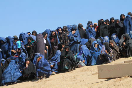 Female Villagers attend the burial ceremony of civilians who were killed by insurgents at Mirza Olang village, in Sar-e Pul province, Afghanistan August 16, 2017. REUTERS/Stringer NO RESALES. NO ARCHIVES