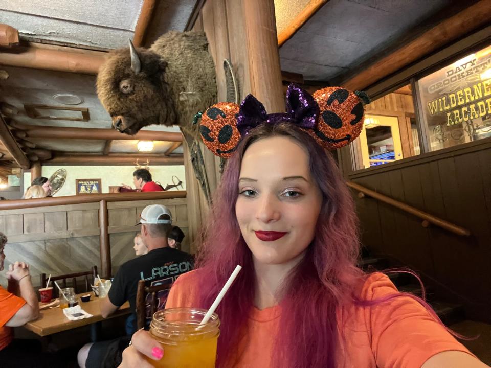 the writer in halloween mickey ears sipping POG juice at trail's end