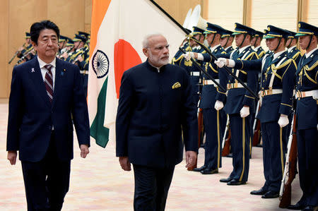 Indian Prime Minister Narendra Modi (2nd L) and his Japanese counterpart Shinzo Abe (L) review an honor guard before their meeting at Abe's official residence in Tokyo, Japan November 11, 2016. REUTERS/Toru Yamanaka/Pool