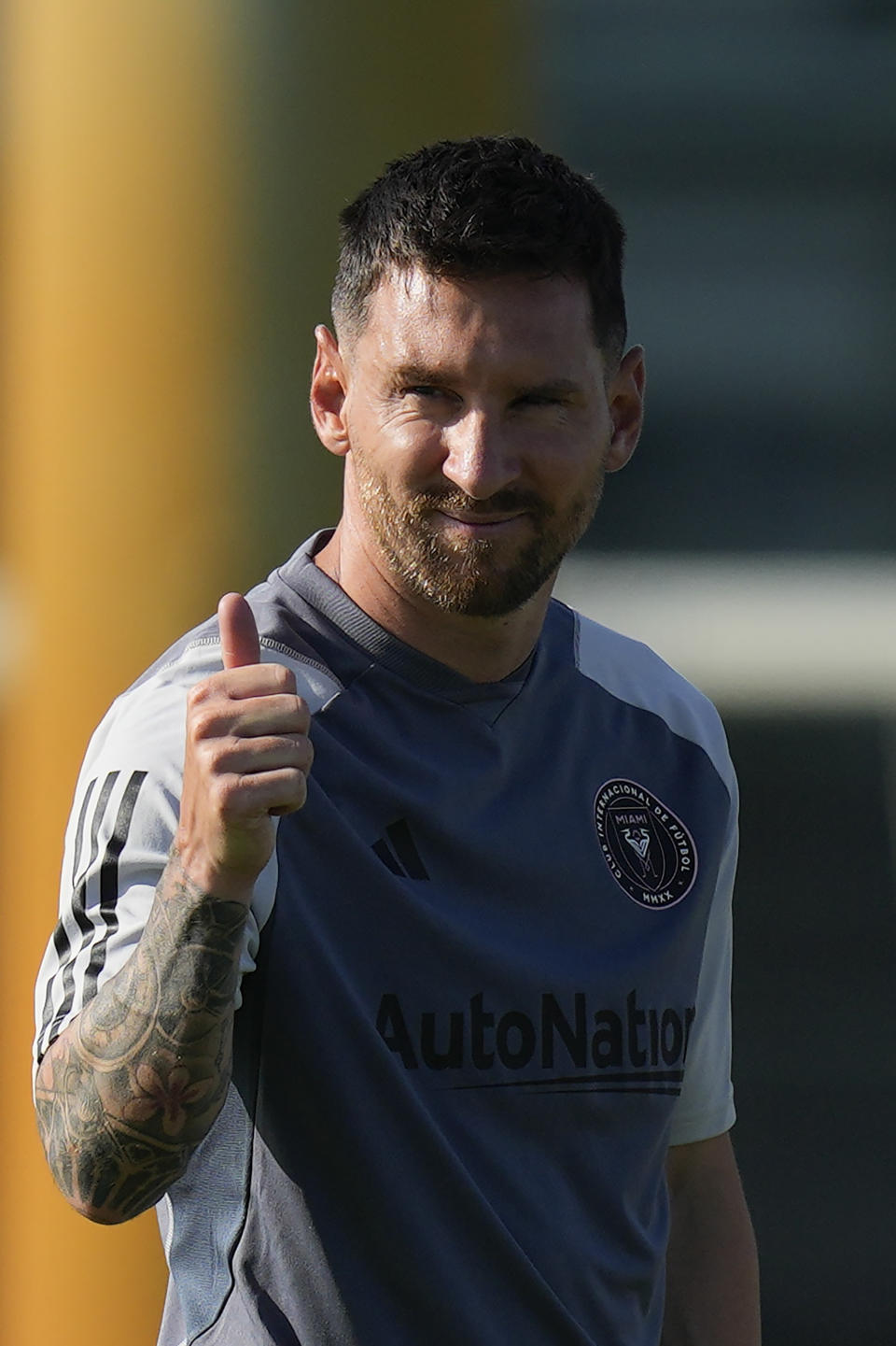 Lionel Messi gives a thumbs up toward journalists on the sideline as he participates in a training session for the Inter Miami MLS soccer team Tuesday, July 18, 2023, in Fort Lauderdale, Fla. (AP Photo/Rebecca Blackwell)