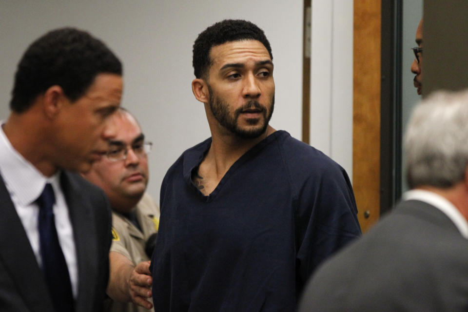 Former NFL football player Kellen Winslow Jr., center, leaves his arraignment Friday, June 15, 2018, in Vista, Calif. The former tight end was arrested Thursday on charges of rape and other sex crimes, the day he was to appear in court on an unrelated burglary charge. (Hayne Palmour/San Diego Union-Tribune via AP, Pool)