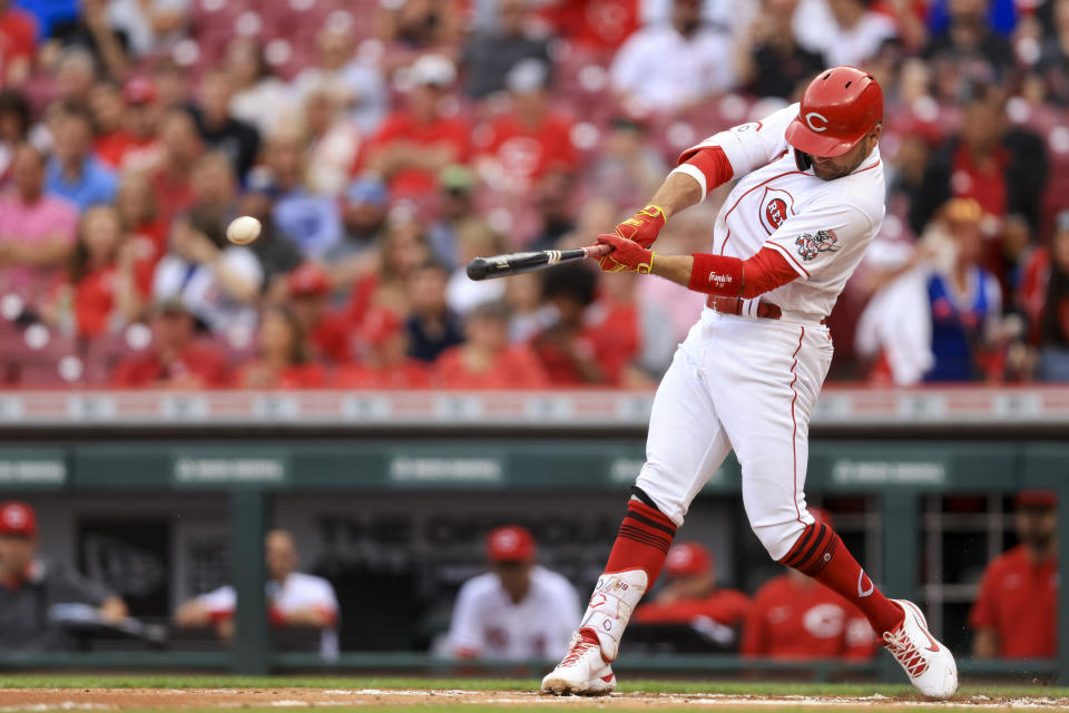 Cincinnati Reds' Joey Votto hits an RBI-single during the first inning of a baseball game against the Chicago Cubs in Cincinnati, Tuesday, May 24, 2022. (AP Photo/Aaron Doster)