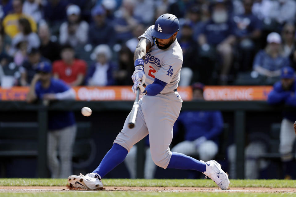 Los Angeles Dodgers' Jason Heyward hits a solo home run on a pitch from Seattle Mariners starting pitcher Logan Gilbert during the first inning of a baseball game, Sunday, Sept. 17, 2023, in Seattle. (AP Photo/John Froschauer)