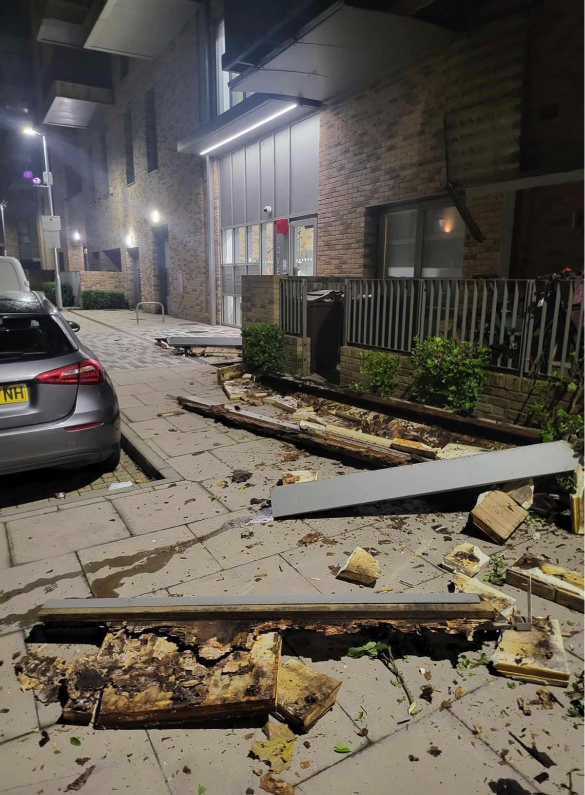 Large pieces of timber and other debris scattered onto a pavement in Barking following the collapse  (Matt Lismore)