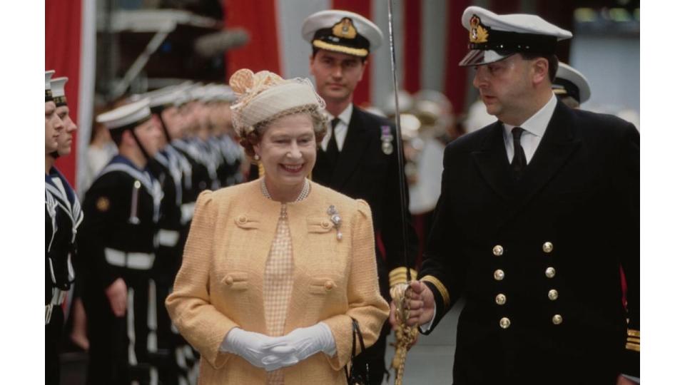 Sir Timothy Laurence walking behind Queen Elizabeth at a navy inspection