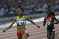 Ethiopia's Meseret Defar (L) celebrates as she wins the gold medal in the women's 5000m final at the athletics event of the London 2012 Olympic Games on August 10, 2012 in London