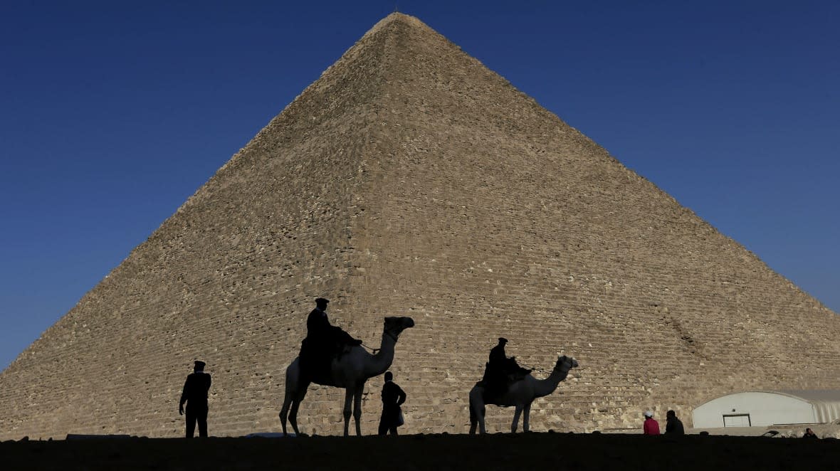 Policemen are silhouetted against the Great Pyramid in Giza, Egypt, Dec 12, 2012. (AP Photo/Hassan Ammar, File)