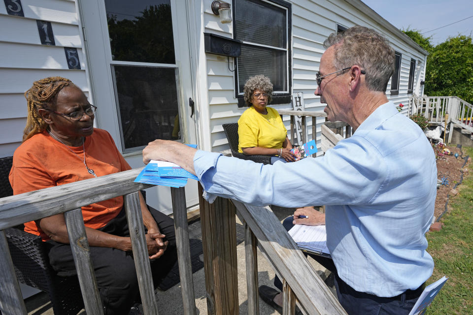 Virginia state Sen. Joe Morrissey, right, talks with constituents Shelly Lyons, left, and Virginia Rawlings, center, as he canvases a neighborhood, Monday, May 22, 2023, in Petersburg, Va. Morrissey is being challenged in a Democratic primary for a newly redrawn senatorial district by former Delegate Lashrecse Aird. (AP Photo/Steve Helber)