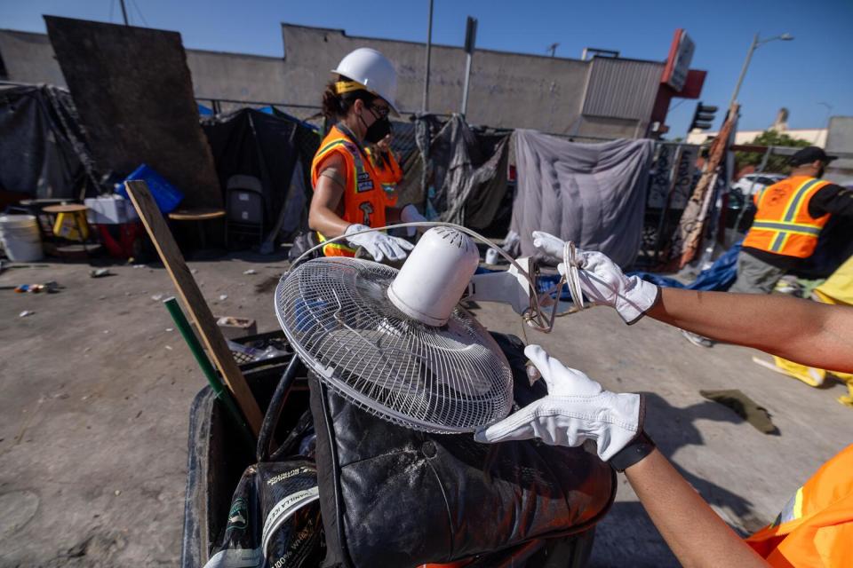 Inside Safe workers clean up a homeless camp in South LA.