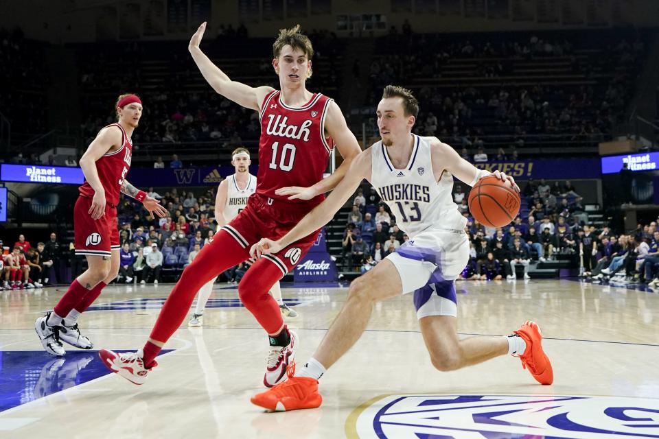 Washington forward Moses Wood (13) drives to the basket against Utah forward Jake Wahlin (10) during the second half of an NCAA college basketball game Saturday, Jan. 27, 2024, in Seattle. Washington won 98-73. | Lindsey Wasson, Associated Press