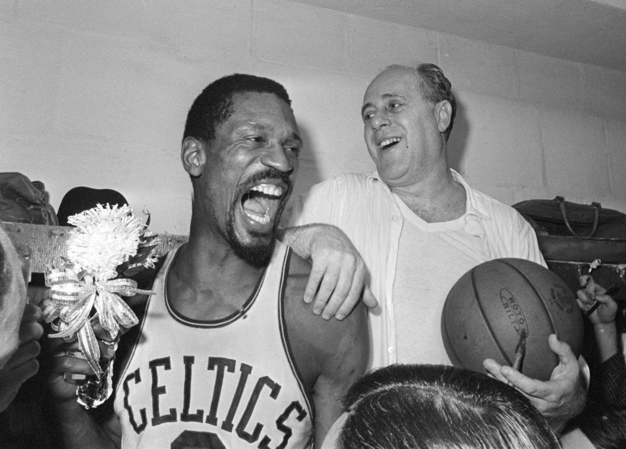 Bill Russell, left, celebrates with Celtics coach Red Auerbach after defeating the Los Angeles Lakers to win their eighth-straight NBA Championship, in Boston, April 29, 1966. <a href="https://newsroom.ap.org/detail/Obit-BillRussellBasketball/54de891d3f834b2b95558fd38c0d476e/photo?Query=(renditions.phototype:horizontal)%20AND%20%20(Bill%20Russell)%20&mediaType=photo&sortBy=arrivaldatetime:desc&dateRange=Anytime&totalCount=998&currentItemNo=10" rel="nofollow noopener" target="_blank" data-ylk="slk:AP Photo/File;elm:context_link;itc:0;sec:content-canvas" class="link ">AP Photo/File</a>