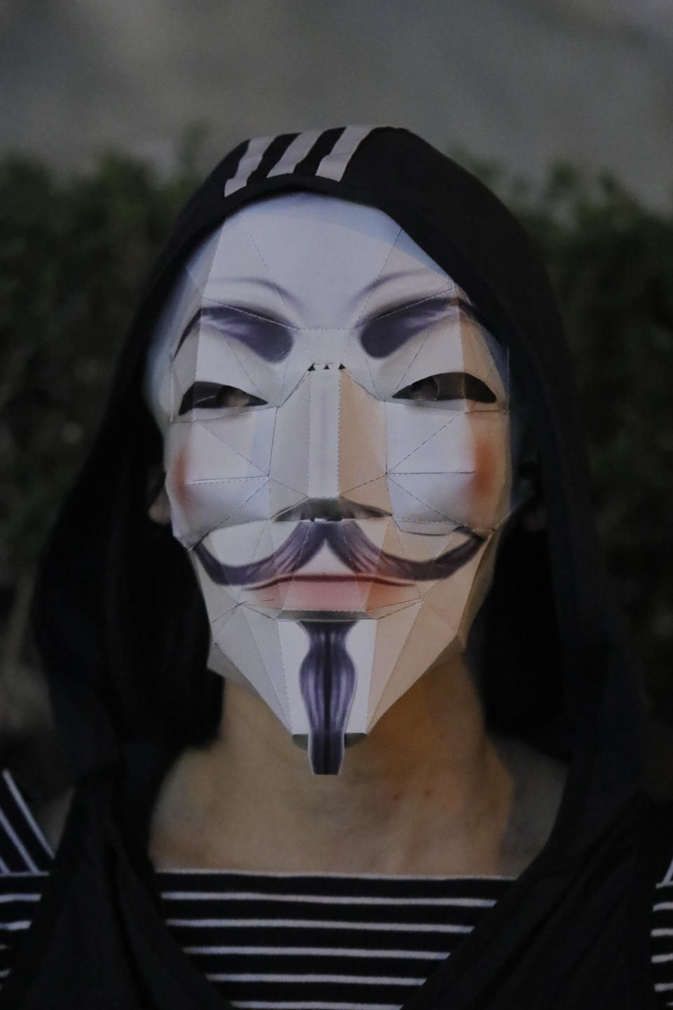 A protester wears a Guy Fawkes mask during a protest in Hong Kong, Friday, Oct. 18, 2019. Hong Kong protesters masqueraded as various characters in defiance of a government ban on face coverings at public gatherings. (AP Photo/Kin Cheung)