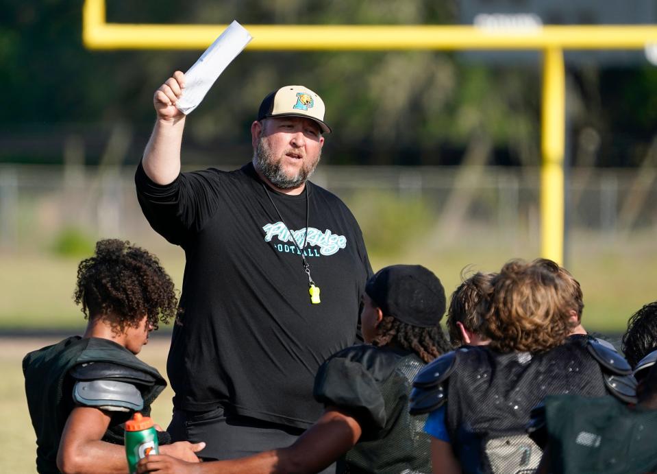 Pine ridge coach Eric Poyner gives instruction during a practice in May.