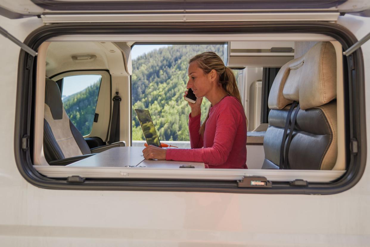 She works remotely from her alternative home in nature and uses mobile phone and computer devices.