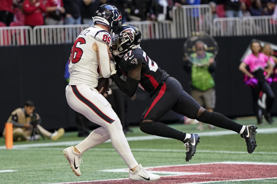 Houston Texans tight end Dalton Schultz (86) scores a touchdown against Atlanta Falcons safety Richie Grant (27) in the second half of an NFL football game in Atlanta, Sunday, Oct. 8, 2023. (AP Photo/Mike Stewart)