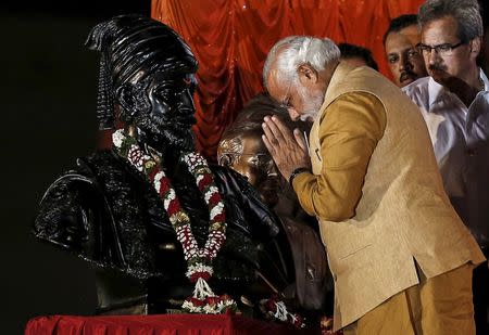 Hindu nationalist Narendra Modi, then-prime ministerial candidate for the main opposition Bharatiya Janata Party (BJP), gestures at the statue of Chhatrapati Shivaji, revered by many in western India as a Hindu warrior king, during an election campaign rally in Mumbai in this April 21, 2014 file photo. REUTERS/Danish Siddiqui/Files