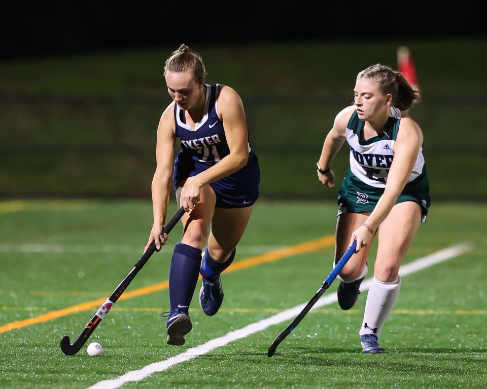 Exeter's Izzy Steiner tries to get around Dover's Kaela Robins during Tuesday's Division I field hockey semifinal.
