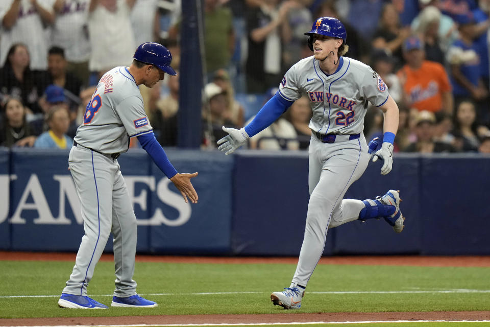 New York Mets' Brett Baty (22) celebrates with third base coach Mike Sarbaugh after hitting a three-run home run off Tampa Bay Rays starting pitcher Aaron Civale during the second inning of a baseball game Friday, May 3, 2024, in St. Petersburg, Fla. (AP Photo/Chris O'Meara)