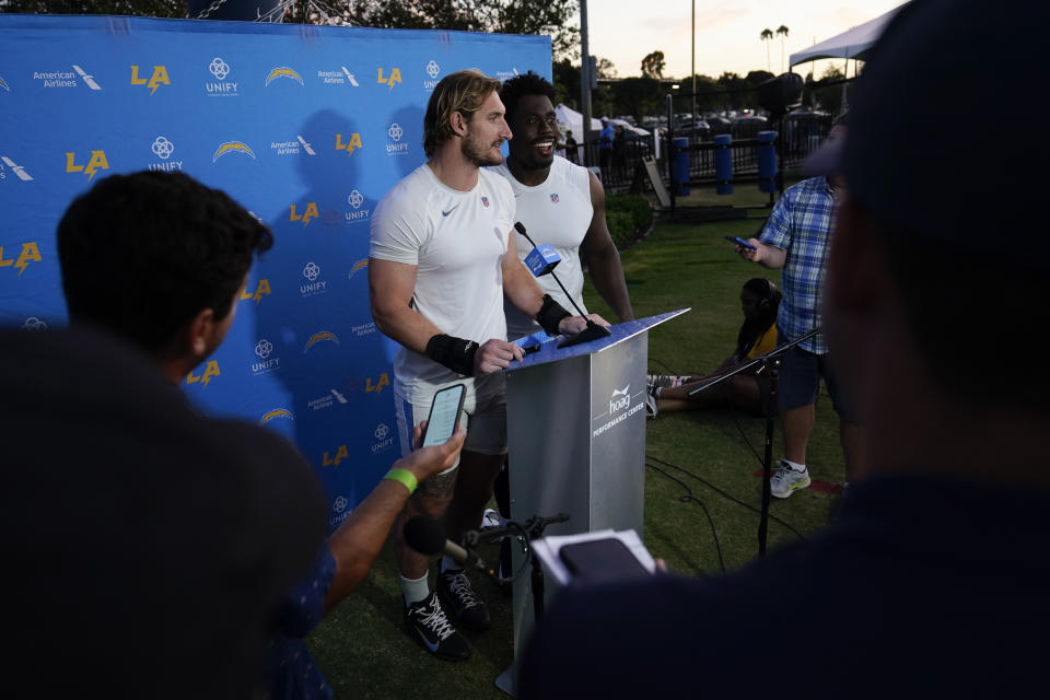 Los Angeles Chargers outside linebacker Joey Bosa, center left, and guard Zion Johnson talk to reporters at the NFL football team's practice facility in Costa Mesa, Calif. Sunday, Aug. 7, 2022. (AP Photo/Ashley Landis)