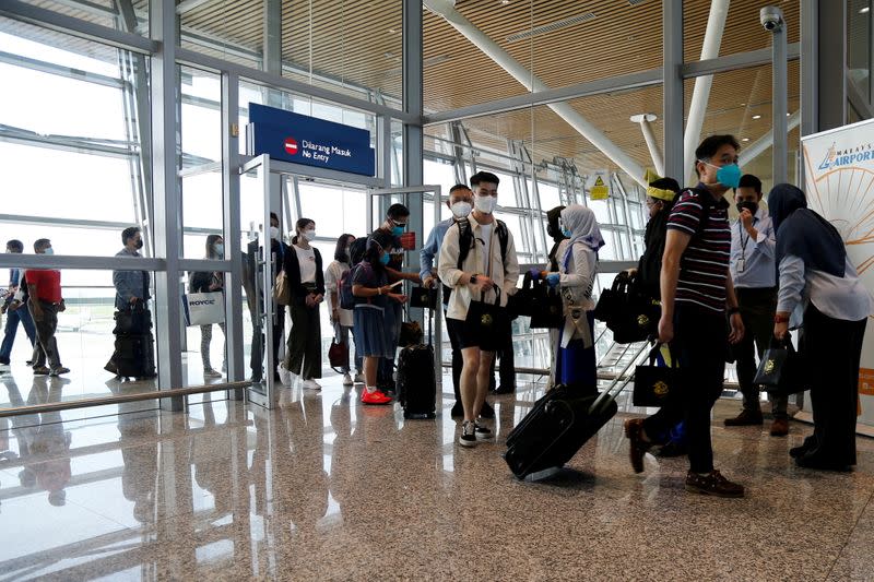 Travellers arrive at Kuala Lumpur International Airport under the Malaysia-Singapore Vaccinated Travel Lane programme, in Sepang