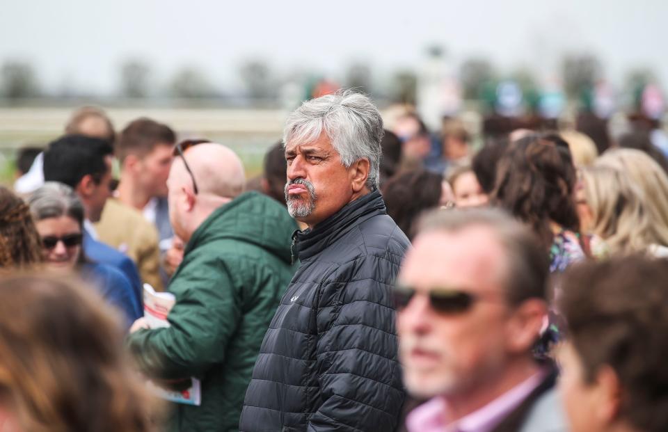 Trainer Steve Asmussen jockeys himself near the front row for the first race at the Spring Meet opening day at Keeneland. April 7, 2023