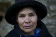 <p>Eudicia Urbano, 70, standing in front of her former home, near the spot where her husband Marcial Escalante died, weeps as she retells how he was tortured and killed by Shining Path rebels, in Chaca, Peru on June 16, 2013. (Photo: Rodrigo Abd/AP) </p>