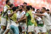 Iran's Rouzbeh Cheshmi, center, celebrates scoring the opening goal with teammates during the World Cup group B soccer match between Wales and Iran, at the Ahmad Bin Ali Stadium in Al Rayyan , Qatar, Friday, Nov. 25, 2022. (AP Photo/Francisco Seco)