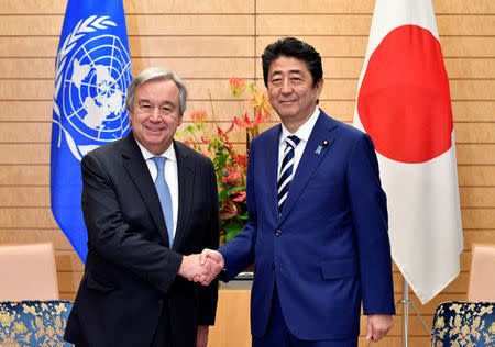 United Nations Secretary-General Antonio Guterres (L) is welcomed by Japan's Prime Minister Shinzo Abe before their meeting at the Prime Minister's official residence in Tokyo, Japan, December 14, 2017. REUTERS/Franck Robichon/Pool