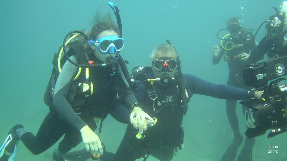 Jessica Pita holds her dive buddy's hand the entire time she's underwater.