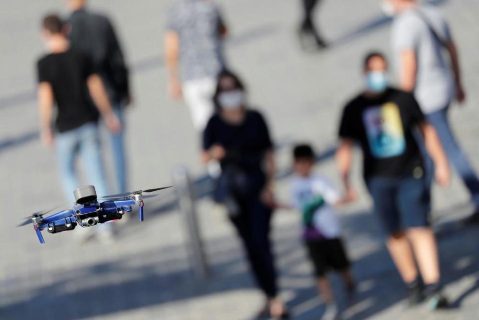 A police drone fitted with a megaphone speaker patrols over Taksim Square in Istanbul searching for people not wearing face masks.