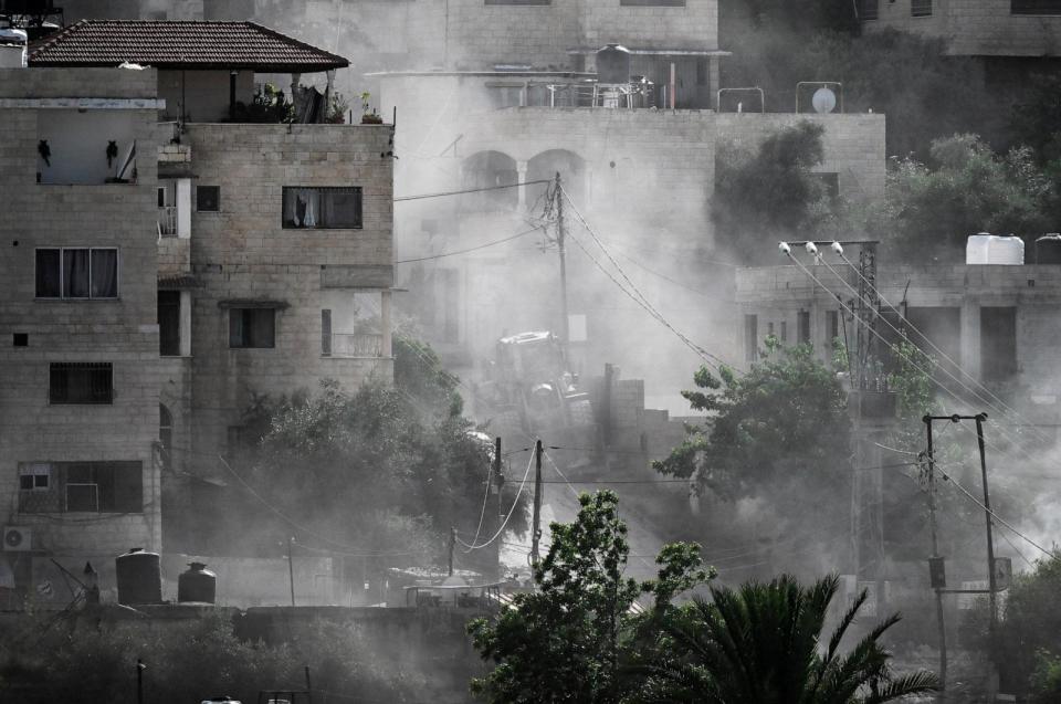 PHOTO: Smoke billows after an explosion targeting an Israeli bulldozer during a raid by Israeli forces in the Jenin refugee camp in the occupied West Bank on May 21, 2024. (Ronaldo Schemidt/AFP via Getty Images)