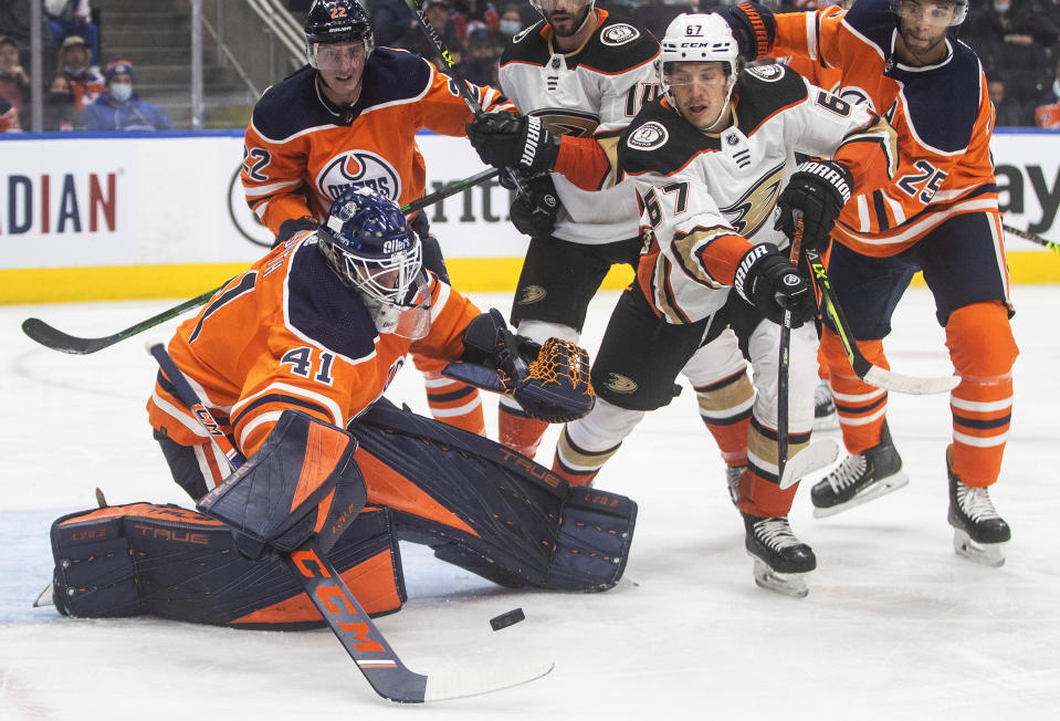 Anaheim Ducks' Rickard Rakell (67) is stopped by Edmonton Oilers goalie Mike Smith (41) during the first period of an NHL hockey game Tuesday, Oct. 19, 2021, in Edmonton, Alberta. (Jason Franson/The Canadian Press via AP)