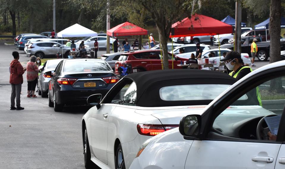 People line up in their cars to receive a second dose of the vaccine.