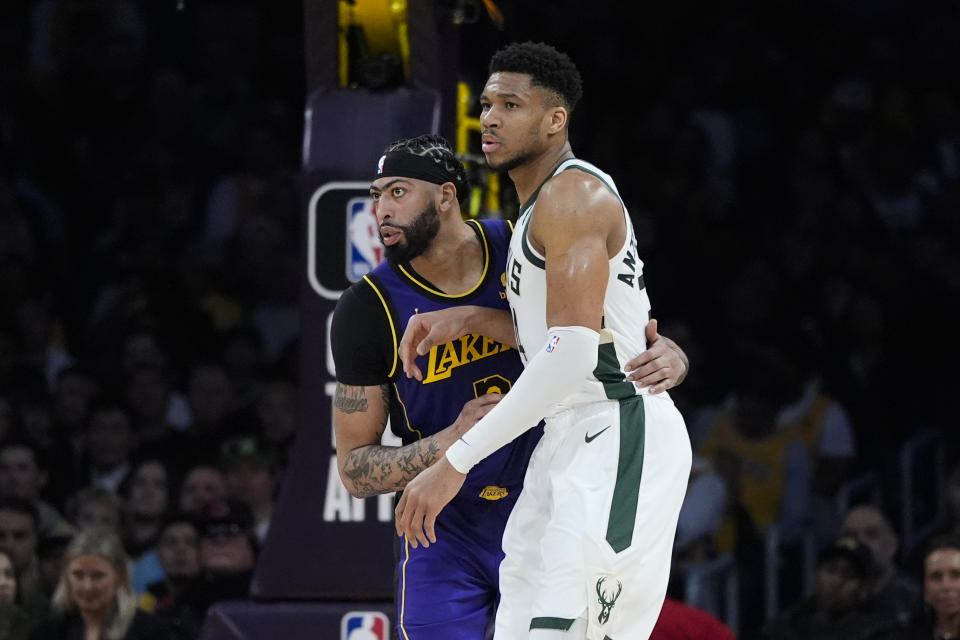 Milwaukee Bucks forward Giannis Antetokounmpo, right, is grabbed by Los Angeles Lakers forward Anthony Davis, left, during the first half of an NBA basketball game Friday, March 8, 2024, in Los Angeles. (AP Photo/Jae C. Hong)