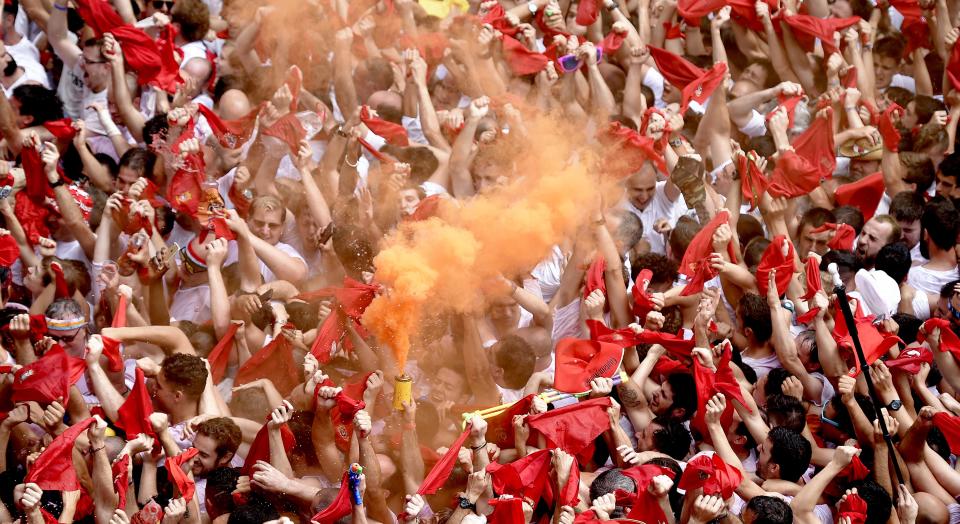 <p>Participants celebrate during the ‘Chupinazo’ (start rocket) to mark the kickoff at noon sharp of the San Fermin Festival, in front of the Town Hall of Pamplona, northern Spain, on July 6, 2018. (Photo: Jose Jordon/AFP/Getty Images) </p>