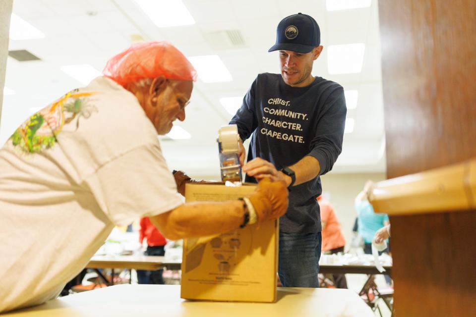 Dylan West, of Baltimore, tapes a box shut during a meal-packing event held by Hanover Against Hunger, Saturday, Nov. 4, 2023, at St. Matthew's Church in Hanover. Over 600 volunteers took part in the event, which raised enough money to pack over 200,000 meals.