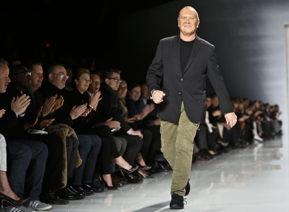 Fashion designer Michael Kors reacts to applause after showing his Fall 2013 collection on Wednesday, Feb. 13, 2013 in New York. (AP Photo/Bebeto Matthews)