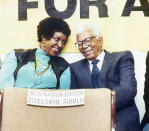 <p>Winnie Mandela, left, talks to recently released ANC leader Walter Sisulu, right, whose son Zwelakhe, editor of the New Nation newspaper under a banning order, may not attend public functions or work as a journalist, at a press conference on Nov. 11, 1989, on the possible suspension of the New Nation by the government. (Photo: Anna Zieminski/AP) </p>