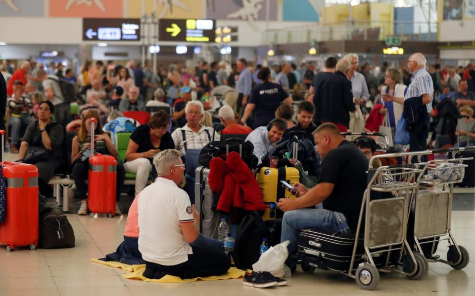 Hundreds of people are stuck waiting for flight information - BORJA SUAREZ/REUTERS