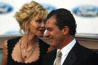 Spanish actor Antonio Banderas (R) and his wife, U.S. actress Melanie Griffith, smile as they pose during a photocall after their arrival at the Starlite Charity Gala in Marbella August 4, 2012. REUTERS/Jon Nazca (SPAIN SOCIETY - Tags: ENTERTAINMENT)