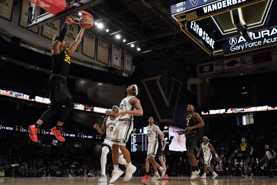 Missouri forward Noah Carter, left, dunks the ball past Vanderbilt guard Jordan Williams (10) and forward Ven-Allen Lubin (2) during the first half of an NCAA college basketball game Saturday, Feb. 3, 2024, in Nashville, Tenn. (AP Photo/George Walker IV)