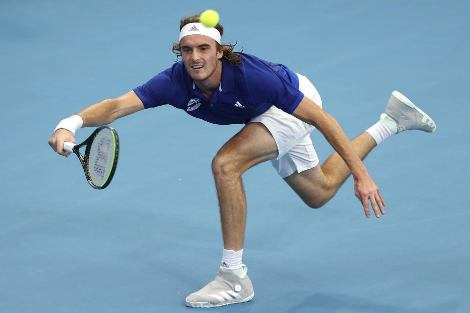 FILE - In this Jan. 3, 2020, file photo, Stefanos Tsitsipas, of Greece, plays a shot during his match against Denis Shapovalov, of Canada, at the ATP Cup tennis tournament in Brisbane, Australia. Tsitsipas will be competing in the Australian Open tennis tournament beginning Monday, Jan. 20, 2020. (AP Photo/Tertius Pickard, File)