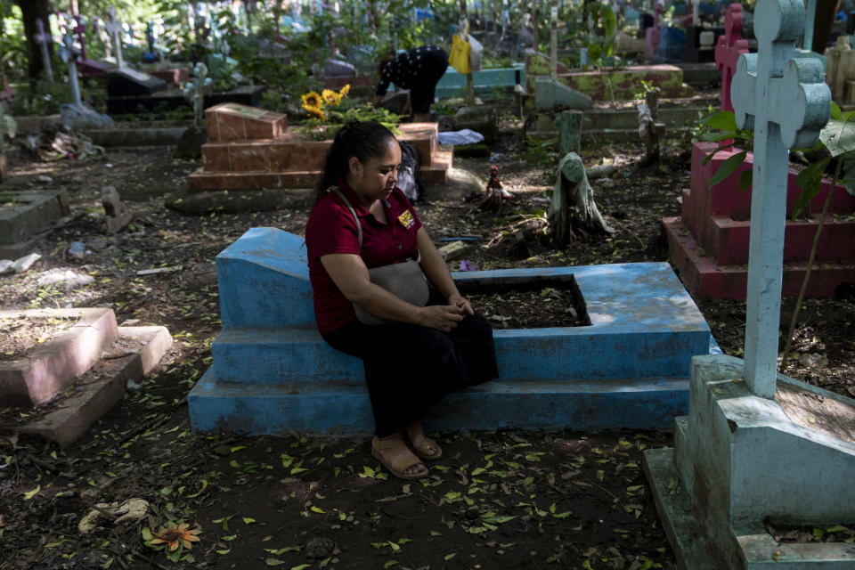 Nancy Cruz de Quintanilla visits her husband’s grave at the cemetery in San Miguel, El Salvador, Thursday, Oct. 13, 2022. Her husband, Jose Mauricio Quintanilla Medrano, a local small businessman and part-time evangelical preacher, was detained under the "state of exception" after a tip about a suspicious person in a neighborhood that was not his own. Days later he was bused to the Mariona prison where he reportedly died of a pulmonary edema. (AP Photo/Moises Castillo)