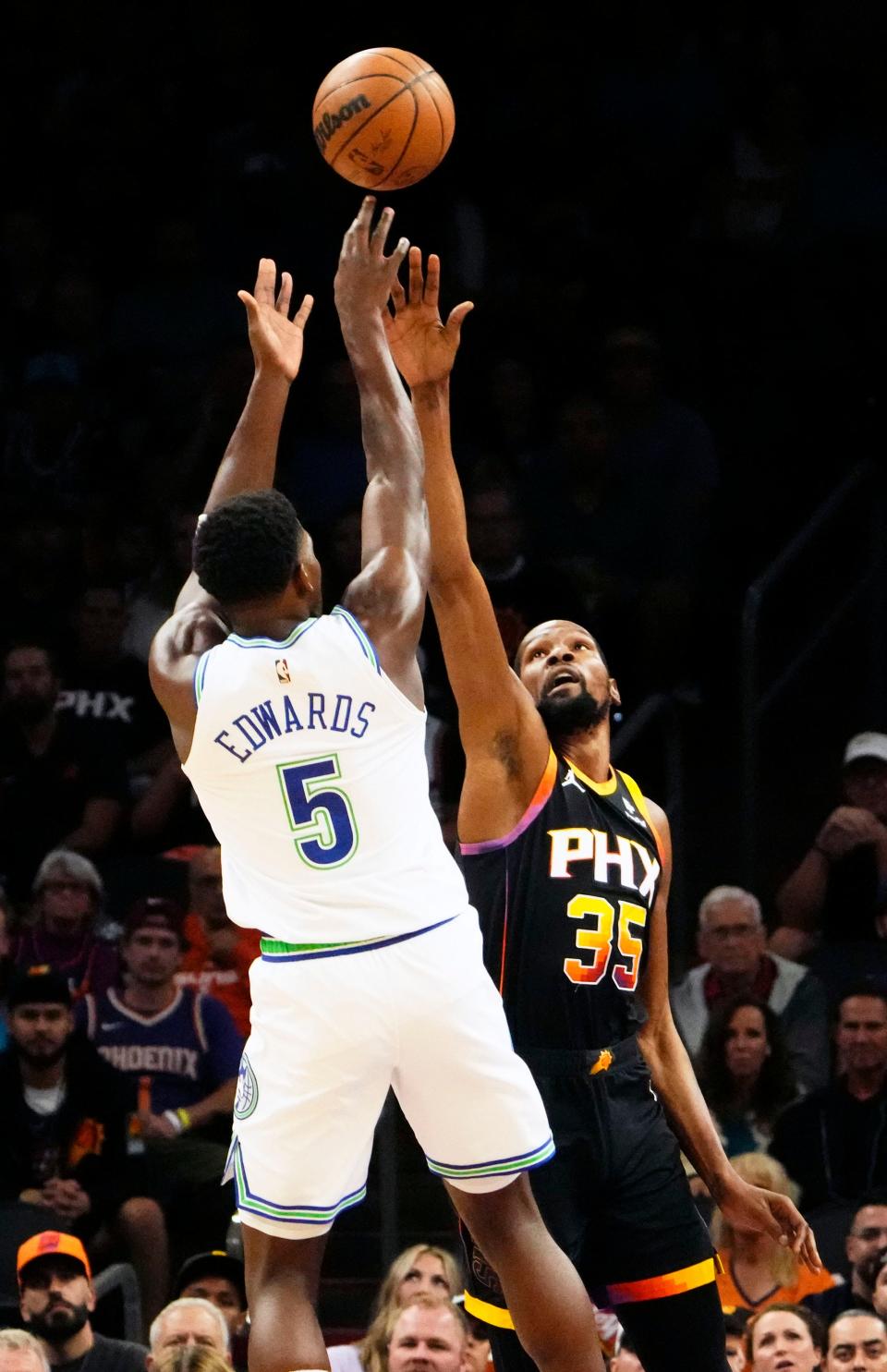 Minnesota Timberwolves guard Anthony Edwards (5) shoots a jumper over Phoenix Suns forward Kevin Durant (35) in the first half at Footprint Center in Phoenix on Nov. 15, 2023.