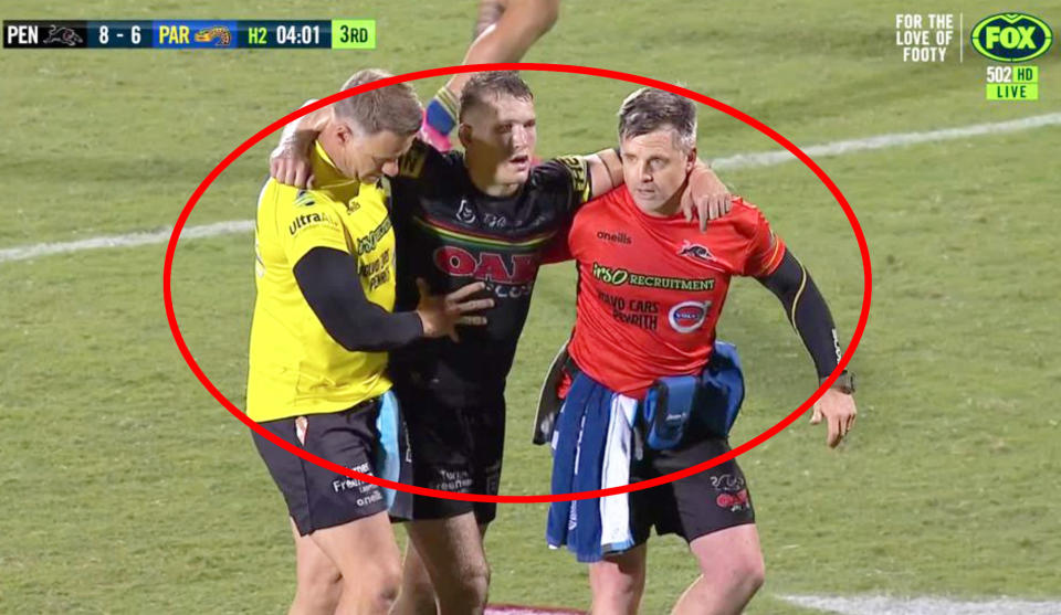 Pictured here, Penrith trainer Pete Green helps Mitch Kenny off the field.