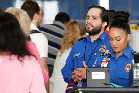 REFILE: UPDATING SLUG TO NEW YORK-AIRPORT/Transportation Security Administration (TSA) agents check-in passengers at JFK airport in the Queens borough of New York City, U.S., May 27, 2016. REUTERS/Brendan McDermid/File Photo