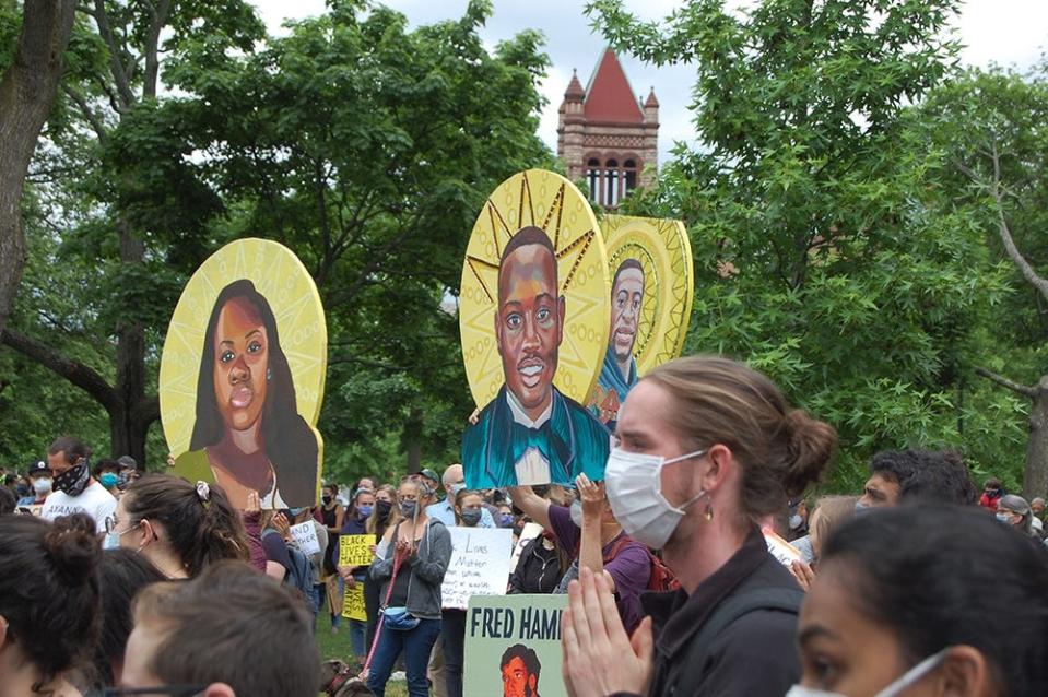 Demonstrators carry handpainted signs of Breonna Taylor, Ahmaud Arbery and George Floyd at a rally in June 2020 at Cambridge Common in Massachusetts.