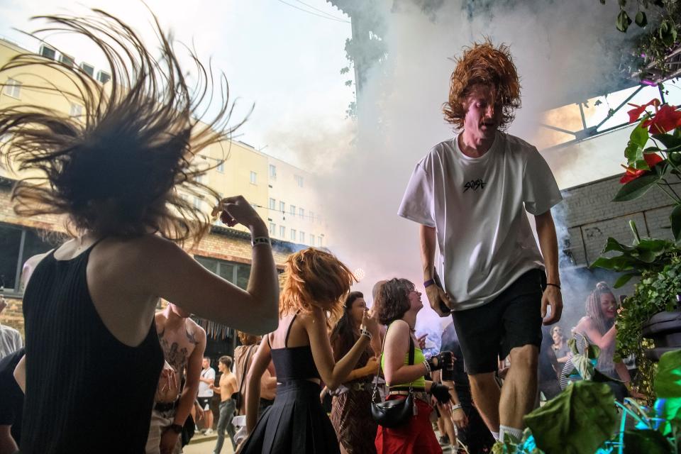 People dance at a rave party in central Kyiv, Ukraine, on August 27, 2022.